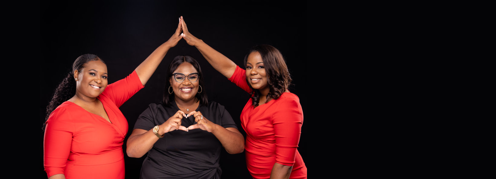 three women forming a triangle with a heart inside